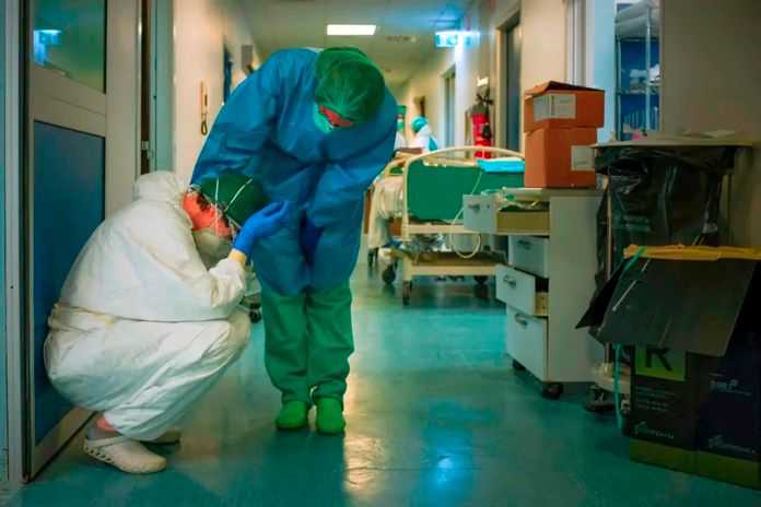 新冠疫情期間，義大利一家醫院的工作人員安慰身心疲憊的同事（法新社資料圖）